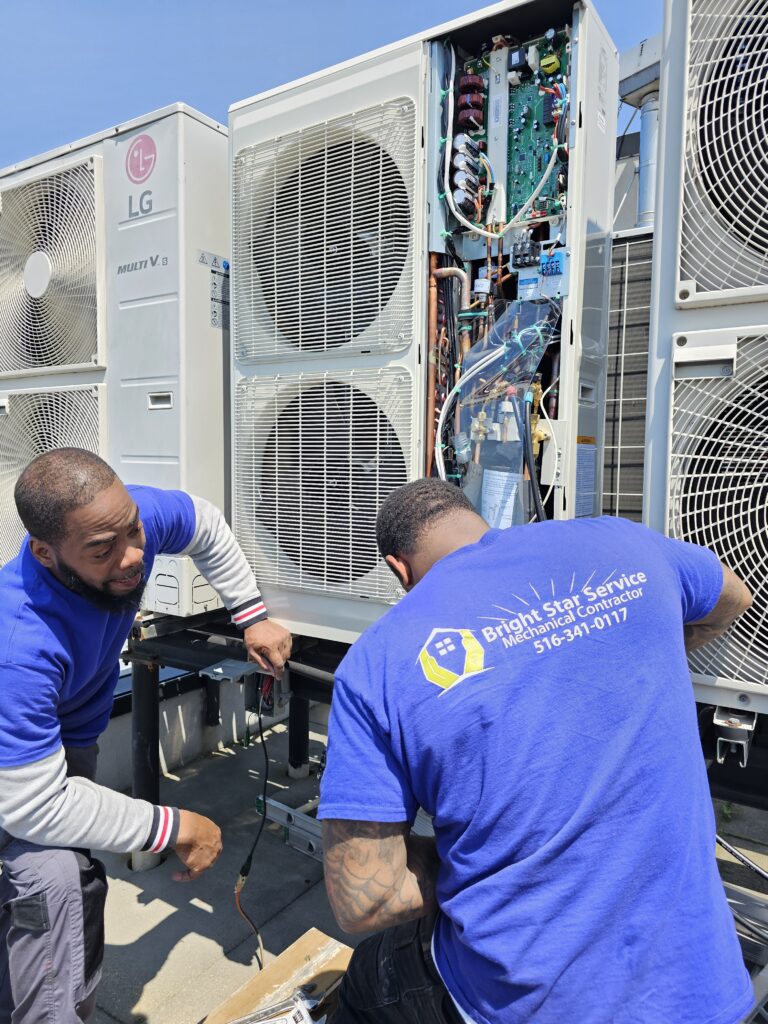 Bright Star Service technicians performing a precision HVAC tune-up on a rooftop unit in Manhattan